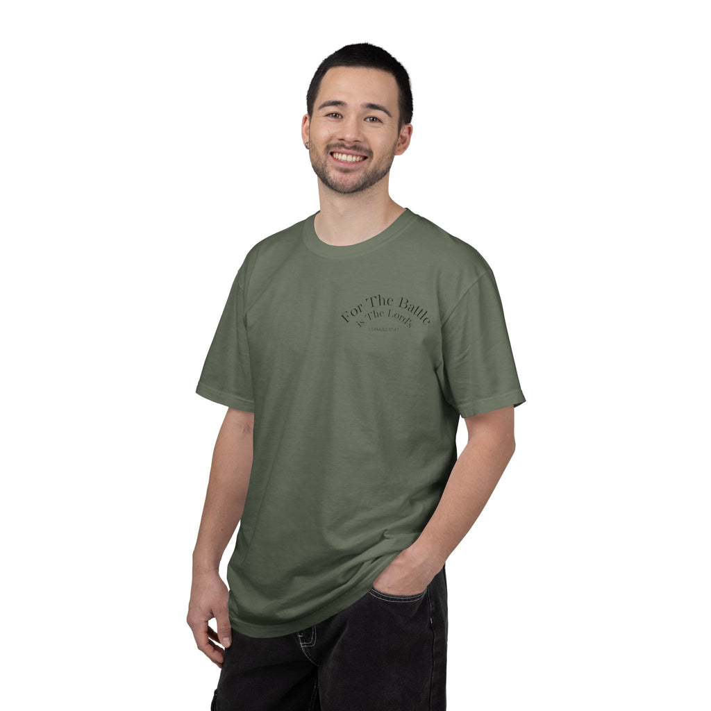 Model wearing a moss green David and Goliath Christian T-shirt featuring a small biblical chest graphic, vintage-inspired Christian clothing with a relaxed fit and faith-based design