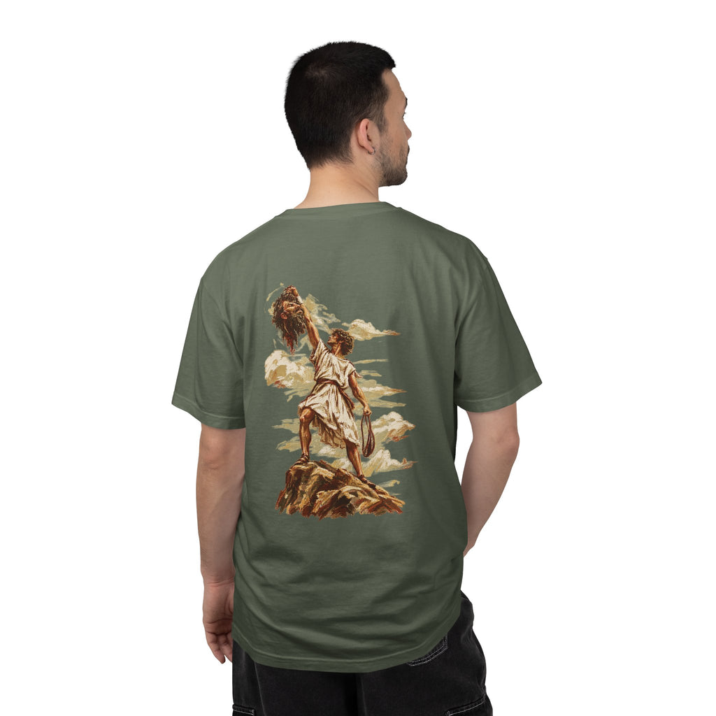 Model wearing a moss green David and Goliath Christian T-shirt featuring detailed vintage-inspired biblical artwork of David and Goliath across the back, faith-based Christian streetwear and biblical graphic apparel